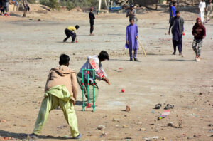 Youngsters enjoying a game of cricket at the local ground.