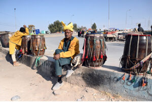 Traditional drum players waiting for clients at their roadside setup.