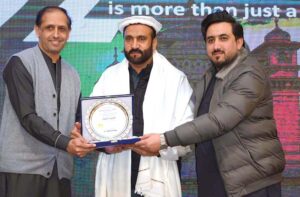 CEO FK Marketing Farhan Khan Khalil presenting a shield to Law minister KPK Aftab Alam afridi during award ceremony.