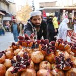 Vendor displaying pomegranate to attract the customer at Kohati area