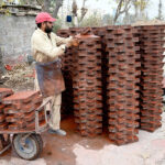 Laborer preparing tuff tiles at his workplace near Pindora area in the City