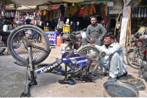 A mechanic is busy repairing a bicycle at Liaquat Market.