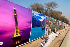 CDA workers paste posters along Srinagar Highway, presenting the beauty of Pakistani culture, in preparation for the Pakistan International Girls Conference, The event set to be inaugurated soon, is expected to welcome delegates from over 40 countries.