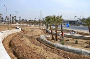 A CDA gardener waters a tree near Aabpara in the Federal Capital.