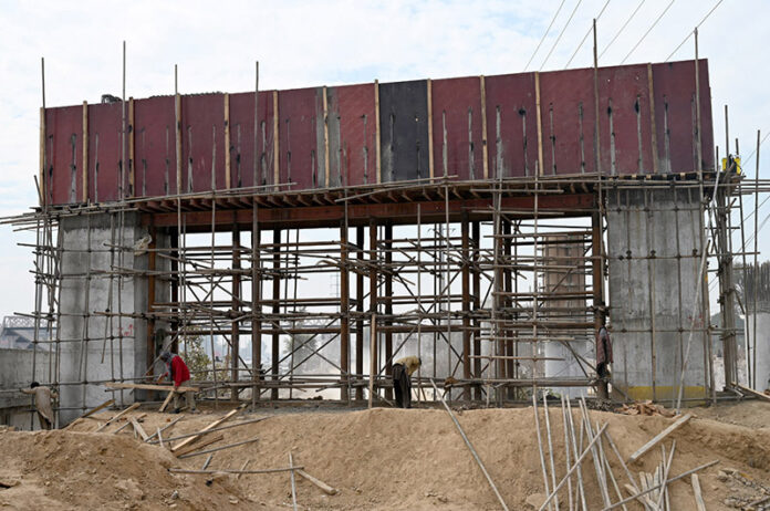 Laborers busy construction of 10th Avenue bridge in the federal capital