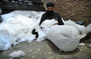 A man use machine to clean cotton, making it fresh and dust-free for refilling pillows and quilts at Dabgari area