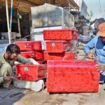 Workers busy preparing the metal iron boxes at their workplace