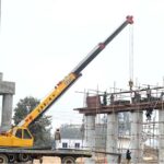 Labourers busy in construction work of flyover at under construction 10th Avenue during development work in Federal Capital