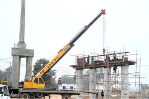 Labourers busy in construction work of flyover at under construction 10th Avenue during development work in Federal Capital