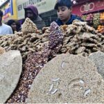 A vendor selling traditional sweet potatoes at Royal Road