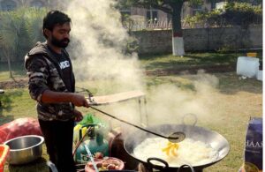A vendor fries crispy potato chips to satisfy the cravings of his customers.