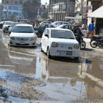 Commuters navigate through pools of accumulated sewerage water at Latifabad Centre, highlighting the need for urgent attention from the concerned authorities