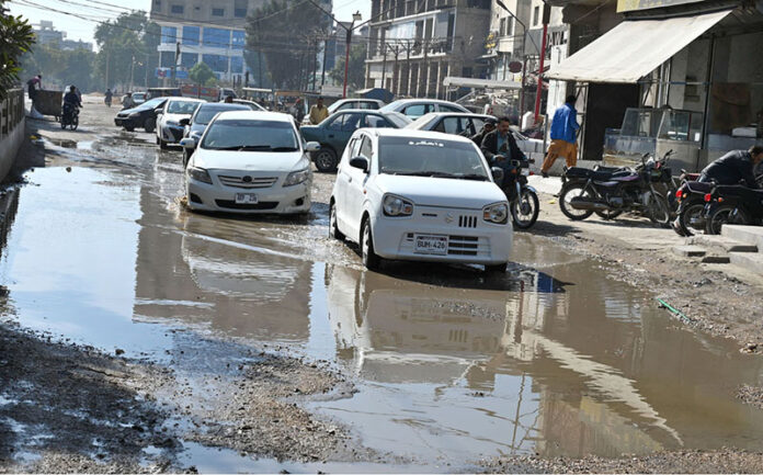 Commuters navigate through pools of accumulated sewerage water at Latifabad Centre, highlighting the need for urgent attention from the concerned authorities