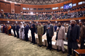Federal Minister for Information and Broadcasting, Attaullah Tarar along with other participants stands in honor of the national anthem during the International Conference on Girls' Education 2025 at Jinnah Convention Centre