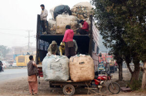 Labourers are busy loading heavy scrap bags on the delivery truck near Rajapur