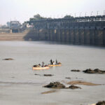 Fishermen cast their net into the Indus River to catch fish, as the demand for fresh fish rises during the winter season