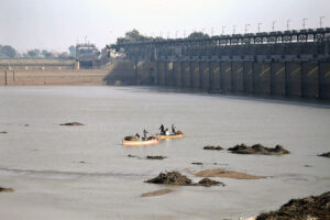 Fishermen cast their net into the Indus River to catch fish, as the demand for fresh fish rises during the winter season