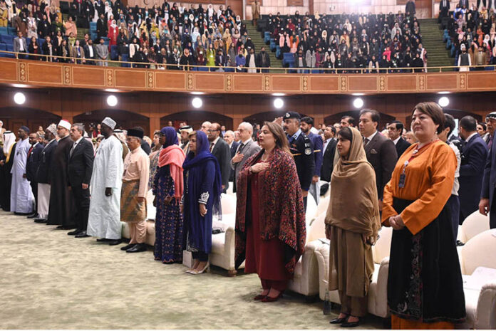Education activist and Nobel Peace Prize winner, Malala Yousafzai along with other participants stands in honor of the national anthem during the International Conference on Girls' Education 2025 at Jinnah Convention Centre