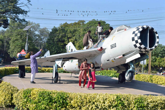 Children visiting the provincial capital play along with the plane enjoying their vacations at China Chowk