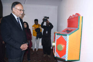 Federal Minister for Planning Development and Special Initiatives Prof. Ahsan Iqbal, watching the exhibition of the Master's Degree Show at the National College of Arts.