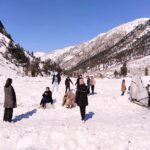 Tourists enjoying a day on snow at Panjota Picnic Point during their visit