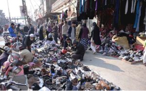 People are purchasing shoes and cloth from Landa bazar.