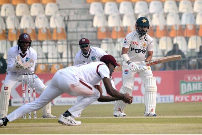 West Indies' Justin Greaves takes a catch to dismiss Pakistan's Saud Shakeel during the third day of the first Test cricket match between Pakistan and West Indies at the Multan Cricket Stadium