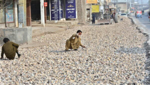 Laborers are busy with construction work on LMQ road during the city development work.