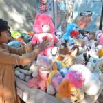A boy selecting toys at a roadside stall in Saddar area