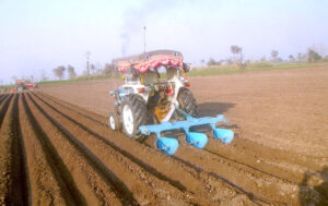 A farmer preparing land for next crop at Faisalabad Road