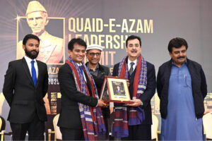 Chairman Senate Syed Yousuf Raza Gillani receives a shield as Chief Guest from Chairman Youth Parliament & Made in Pakistan Movement Rizwan Jaffar during the Quaid-e-Azam Leadership Summit & National Leadership Awards, with Sindh Ministers Saeed Ghani and Syed Sardar Ali Shah also present in provincial capital