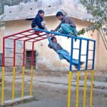 youngsters enjoy swings at Local Park in the city