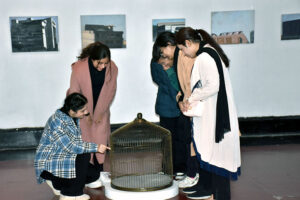 Female students admire the creative art pieces on display at the Master's Degree Show exhibition, held at Shakir Ali Auditorium, National College of Arts in the city .