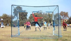 A goalkeeper stops the ball during a handball match between the Faisalabad Board and the Peshawar Board at the Pakistan Inter Board Handball Championship at BISE Ground in the city.