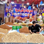 A dry fruit vendor arranging a variety of dry fruits on Sunderdas Road as cold weather sets in