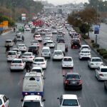 A massive traffic jam clogs the Islamabad Expressway, with seemingly endless queues of cars, buses, and motorcycles stretching as far as the eye can see in the Federal Capital