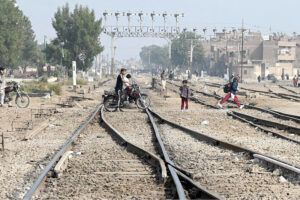 A motorcyclist crossing the railway track near railway station