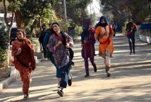 Female enthusiastic candidates participate in a race, aiming to cover one mile in ten minutes as part of the physical test for recruitment in Punjab Police.