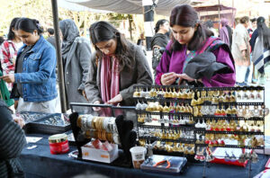 Students looking at artificial jewelry on display at Kinnaird College