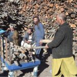 A customer buying wood for domestic use as demand rises with the drop in temperature amid chilling cold weather