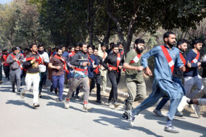 Female enthusiastic candidates participate in a race, aiming to cover one mile in ten minutes as part of the physical test for recruitment in Punjab Police.