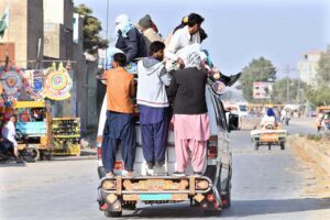 Overloaded van carrying passengers in a dangerous manner on Larkana-Dokri Road, posing a risk of mishap, needs immediate attention from authorities in the city.