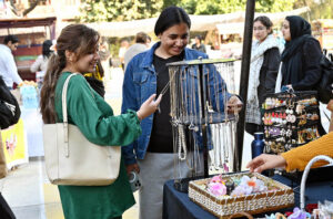 Students looking at artificial jewelry on display at Kinnaird College