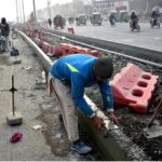 Laborer is busy construction work on footpath at walton Road