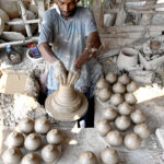 An artisan preparing clay-made stuff at his work place at Kumharpara