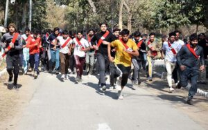 Female enthusiastic candidates participate in a race, aiming to cover one mile in ten minutes as part of the physical test for recruitment in Punjab Police.