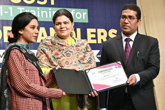 Director General Food Authority, Asim Javed is distributing certificates among the female students at a training ceremony organized by the Food Authority Department on the importance of nutrition for girls at Kinnaird College
