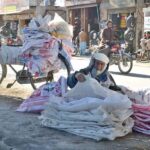 An old man collecting used flour bags to earn his livelihood
