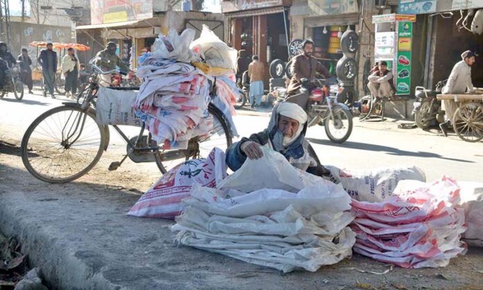 An old man collecting used flour bags to earn his livelihood