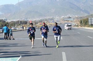 A woman reached the finishing line as a large number of people participated in the Islamabad Marathon 2025 organized by “Islamabad Run with Us